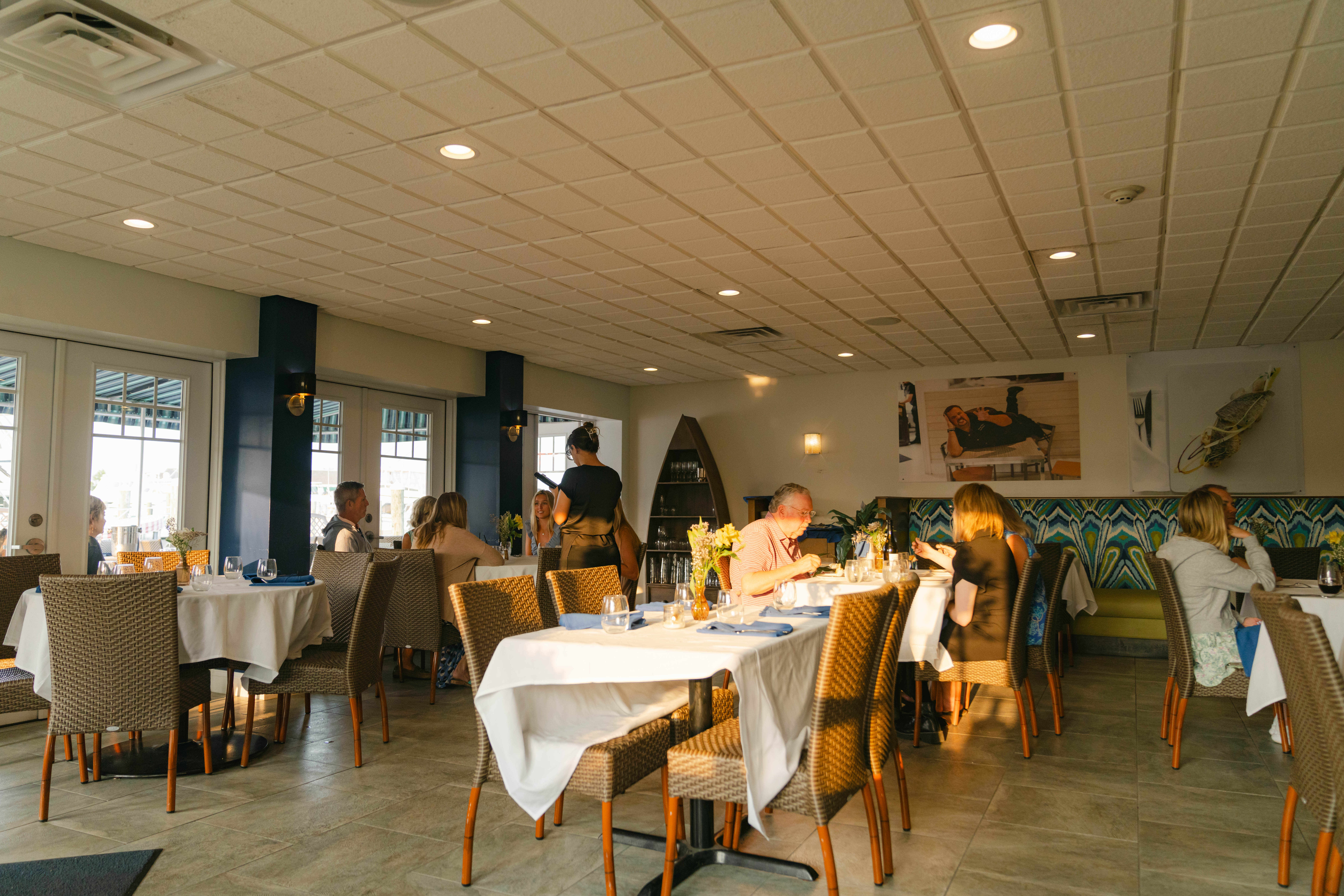 Interior Dining Room at Bryne BYOB - shows room brightly lit by sunshine and happy diners gathered around tables.